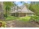 Charming two-story home featuring a large covered front porch with rocking chairs and green lawn at 27091 Country Oak Dr, Brooksville, FL 34602
