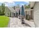 Exterior view of home showing the paved patio with tables, umbrellas, and seating at 27091 Country Oak Dr, Brooksville, FL 34602