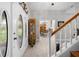 Welcoming foyer highlighting a decorative front door, striped wallpaper, and a glimpse into the dining area at 27091 Country Oak Dr, Brooksville, FL 34602
