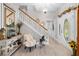 Charming foyer showcasing striped wallpaper, a decorative front door, and a cozy seating area with a rocking horse at 27091 Country Oak Dr, Brooksville, FL 34602