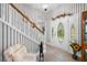 Stylish foyer featuring a decorative front door, striped wallpaper, and light wood flooring for a welcoming entrance at 27091 Country Oak Dr, Brooksville, FL 34602