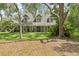 Charming home featuring a covered front porch with rocking chairs and mature trees in yard at 27091 Country Oak Dr, Brooksville, FL 34602