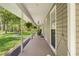 Comfortable covered porch featuring hanging plants and rocking chairs at 27091 Country Oak Dr, Brooksville, FL 34602