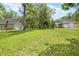 Garage surrounded by green lawn and mature trees at 27091 Country Oak Dr, Brooksville, FL 34602