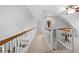Bright upper hallway with railing overlooking below, offering seamless transition between spaces at 27091 Country Oak Dr, Brooksville, FL 34602