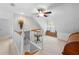 Bright upstairs hall featuring a storage bench and a view of the stairway and hallway below at 27091 Country Oak Dr, Brooksville, FL 34602