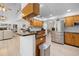Open kitchen featuring oak cabinets, black countertops, stainless steel appliances, and a peninsula with seating at 27091 Country Oak Dr, Brooksville, FL 34602