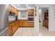 Well-lit kitchen boasting wood cabinets, stainless steel appliances, and easy access to the rest of the home at 27091 Country Oak Dr, Brooksville, FL 34602