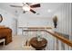 Upstairs landing featuring white railing and a decorative table at 27091 Country Oak Dr, Brooksville, FL 34602