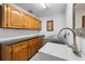 Functional laundry room with wood cabinets, sink, and modern washer and dryer units at 27091 Country Oak Dr, Brooksville, FL 34602
