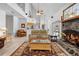 Expansive living room with vaulted ceilings, a stone fireplace, and an open layout for modern living at 27091 Country Oak Dr, Brooksville, FL 34602