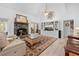 Bright and inviting living room with a stone fireplace, stylish decor, and plenty of seating space at 27091 Country Oak Dr, Brooksville, FL 34602