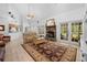 Open-concept living room with stone fireplace, vaulted ceilings, and access to the back patio at 27091 Country Oak Dr, Brooksville, FL 34602