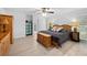 A well-lit main bedroom boasts wood floors, a ceiling fan, and an attached bathroom at 27091 Country Oak Dr, Brooksville, FL 34602