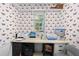 Office space featuring orange and white wallpaper, a desk, and neutral-colored carpeting at 27091 Country Oak Dr, Brooksville, FL 34602