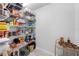 Organized pantry with wire shelves and various food items and home goods at 27091 Country Oak Dr, Brooksville, FL 34602
