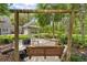 Inviting backyard patio area with wooden swing and comfortable seating arrangement at 27091 Country Oak Dr, Brooksville, FL 34602
