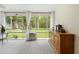 Bright sunroom features tile floors, large windows, and views of the landscaped backyard at 27091 Country Oak Dr, Brooksville, FL 34602