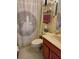 Cozy bathroom featuring a lighthouse-themed shower curtain and light wood-tone vanity at 2930 Plantain Dr, Holiday, FL 34691