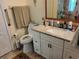 Bright bathroom features granite countertops, cabinets, and grab bars for accessibility at 2930 Plantain Dr, Holiday, FL 34691