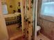 Accessible bathroom connected to a bedroom with matching decor and a rolling walker at 2930 Plantain Dr, Holiday, FL 34691