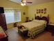 Cozy bedroom with ceiling fan and a comfortable-looking bed and yellow walls at 2930 Plantain Dr, Holiday, FL 34691
