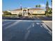 Clubhouse exterior featuring ample parking, an American flag, and tropical landscaping for a community gathering space at 2930 Plantain Dr, Holiday, FL 34691