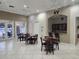 A clubhouse meeting area with tile flooring, ceiling fans and a small bar area at 2930 Plantain Dr, Holiday, FL 34691