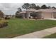 Charming single-story home with a well-manicured lawn and landscaping at 2930 Plantain Dr, Holiday, FL 34691