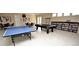 Clubhouse game room with tile flooring, ping pong table, pool table and seating at 2930 Plantain Dr, Holiday, FL 34691