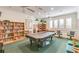 Game room featuring a pool table, reading nooks and bookshelves for entertainment and relaxation at 2930 Plantain Dr, Holiday, FL 34691