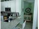 Bright kitchen with white cabinets, quartz countertops, and bar seating at 2930 Plantain Dr, Holiday, FL 34691