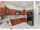 Additional kitchen area featuring abundant cabinet storage, a modern microwave, and a refrigerator at 2930 Plantain Dr, Holiday, FL 34691