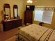 Comfortable main bedroom with matching wood furniture and a large window at 2930 Plantain Dr, Holiday, FL 34691