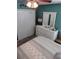 Main bedroom boasts a white dresser, mirror, and bedding, offering a relaxing and inviting space at 2930 Plantain Dr, Holiday, FL 34691
