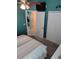 Neutral-toned main bedroom with bright blue accent wall, closet, and view to hallway at 2930 Plantain Dr, Holiday, FL 34691