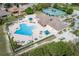 Aerial view of a pool with an attached playground, tennis courts and volleyball court at 2930 Plantain Dr, Holiday, FL 34691