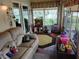 Bright sunroom with comfortable seating, playroom, and tons of natural light at 2930 Plantain Dr, Holiday, FL 34691