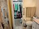 Open walk-in closet with ample storage, metal shelving and grab bars in adjacent shower at 2930 Plantain Dr, Holiday, FL 34691