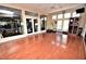 Bright yoga studio featuring wood floors, multiple windows, and mirrors for fitness and wellness activities at 2930 Plantain Dr, Holiday, FL 34691