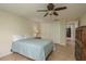 Inviting bedroom with a ceiling fan, closet, and a door to another room at 3140 Bahia Ave, Holiday, FL 34690