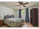Comfortable bedroom with neutral walls, a ceiling fan, and a window overlooking the yard at 3140 Bahia Ave, Holiday, FL 34690