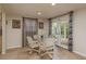Cozy breakfast nook features a glass table, four chairs, neutral walls, and double doors to the backyard at 3140 Bahia Ave, Holiday, FL 34690