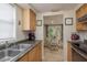 Well-lit kitchen with views of dining area and functional appliances at 3140 Bahia Ave, Holiday, FL 34690