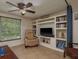 Comfortable seating area with a built-in bookcase, TV and natural light from window at 3140 Bahia Ave, Holiday, FL 34690