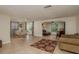 Spacious living room with tile floors, rug, and views to dining and living areas at 3140 Bahia Ave, Holiday, FL 34690