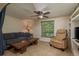 Cozy living room featuring a comfortable sofa, ceiling fan and built-in shelving at 3140 Bahia Ave, Holiday, FL 34690
