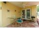 Cozy outdoor patio with a ceiling fan, dining table, and grill, perfect for entertaining at 3140 Bahia Ave, Holiday, FL 34690