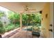 Covered patio with seating area and a view of the lush backyard at 3140 Bahia Ave, Holiday, FL 34690