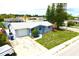 Aerial view of a home with driveway, garage, and spacious yard in a residential neighborhood at 3151 Wellington Dr, Holiday, FL 34691